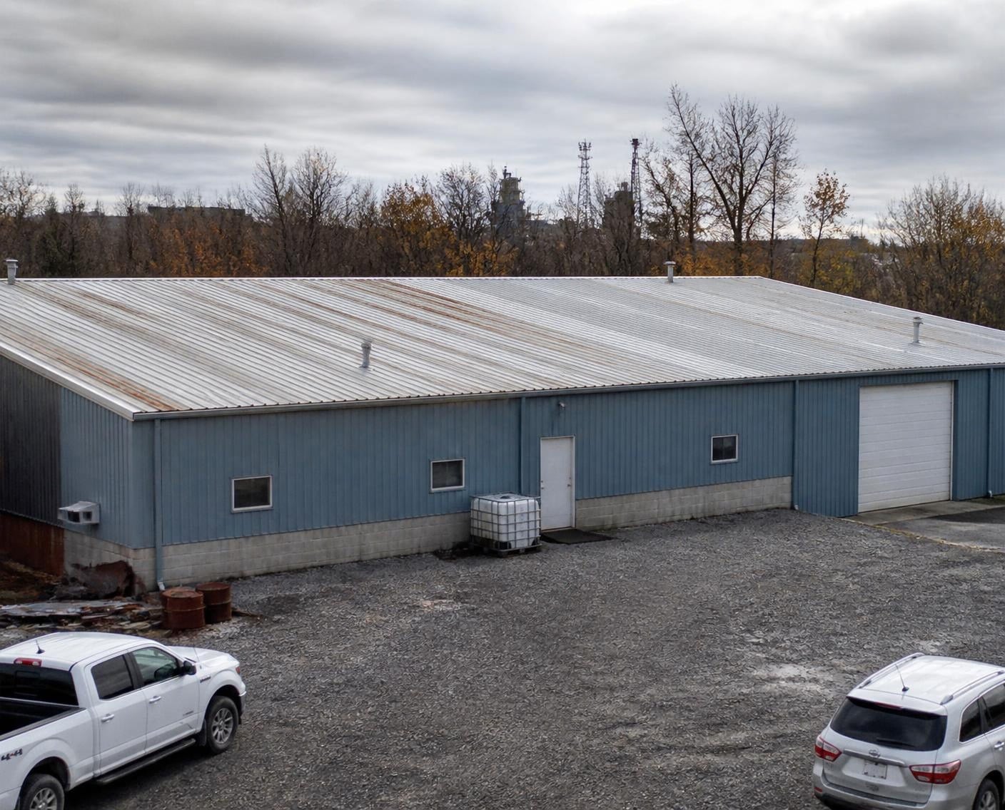 Warehouse with a rust-streaked metal roof, a typical coating candidate